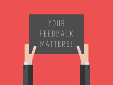 Graphic of two hands against a red background holding up a black sign with white writing that reads "YOUR FEEDBACK MATTERS!"