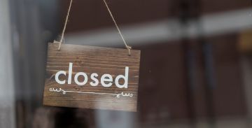 Closed sign hanging in window