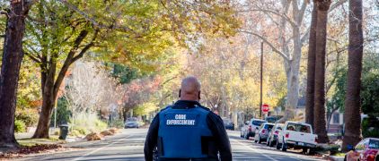 Code enforcement officer walking - view from the back