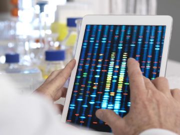 Hand scrolling iPad showing DNA results