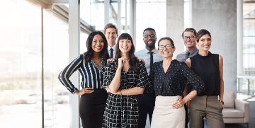 Diverse group of individuals in business attire standing in a group