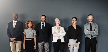 Diverse group of individuals in business attire standing in a line