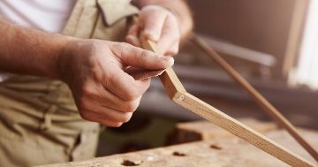 Person sanding a picture frame