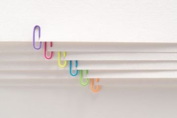 Stack of papers with different colored paper clips