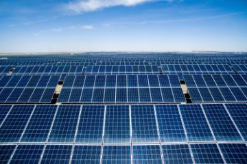 Rows of solar panels with blue sky