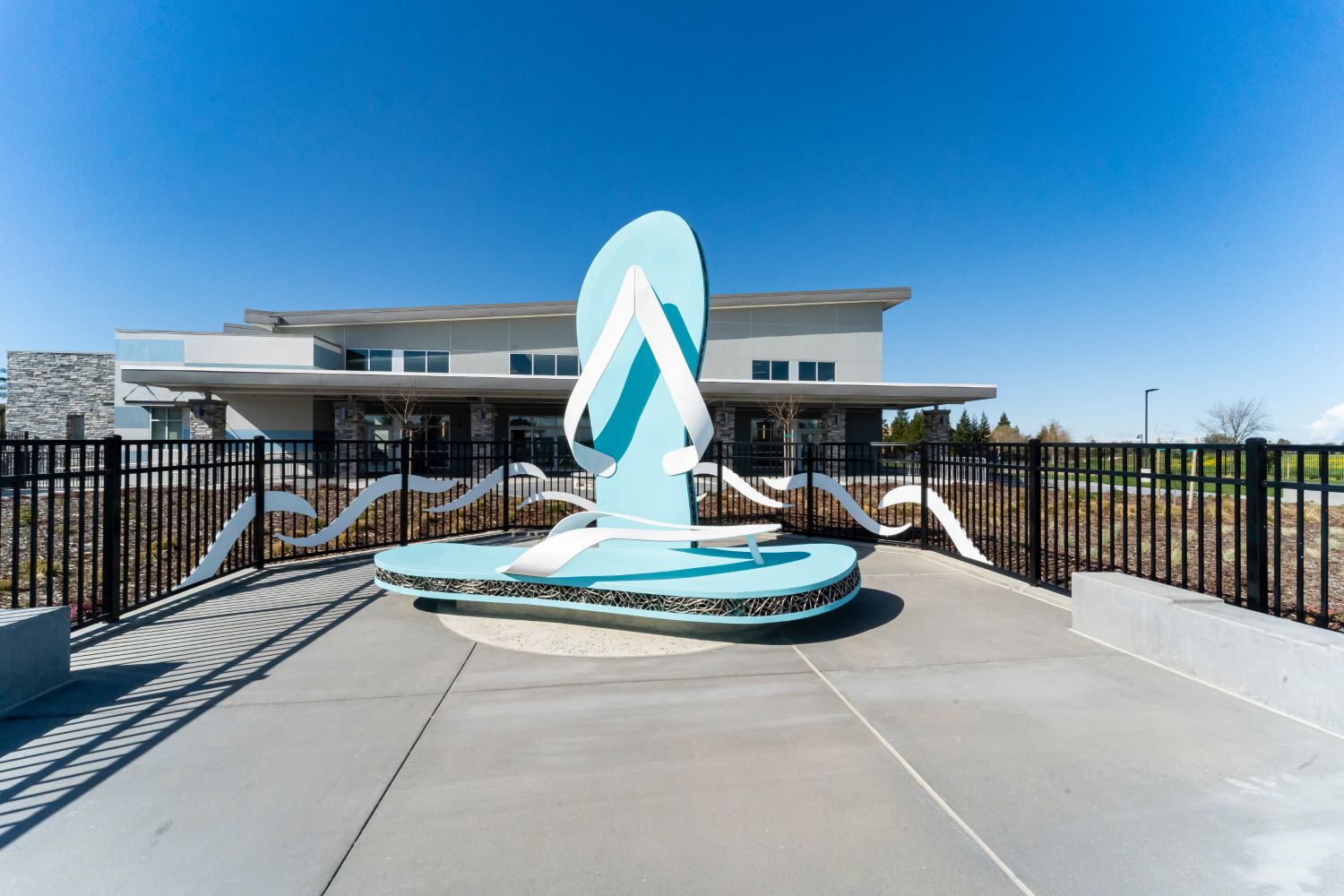Large light blue flip flops create a bench to sit on by the pool