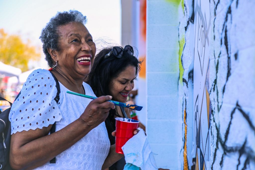 Woman smiling at mural