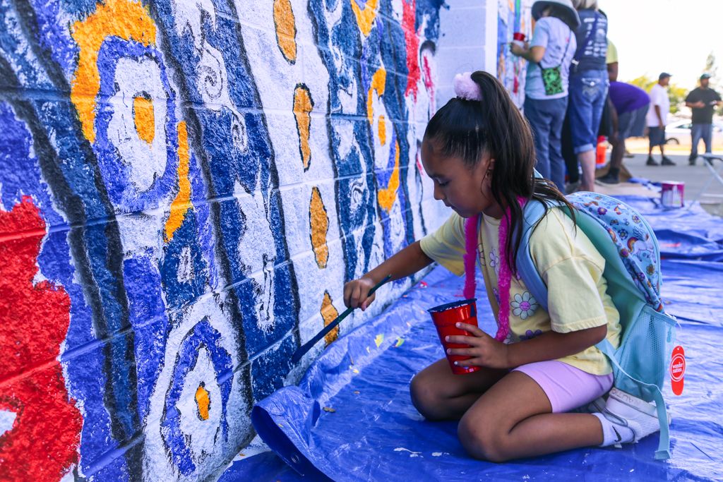 Image of child painting mural