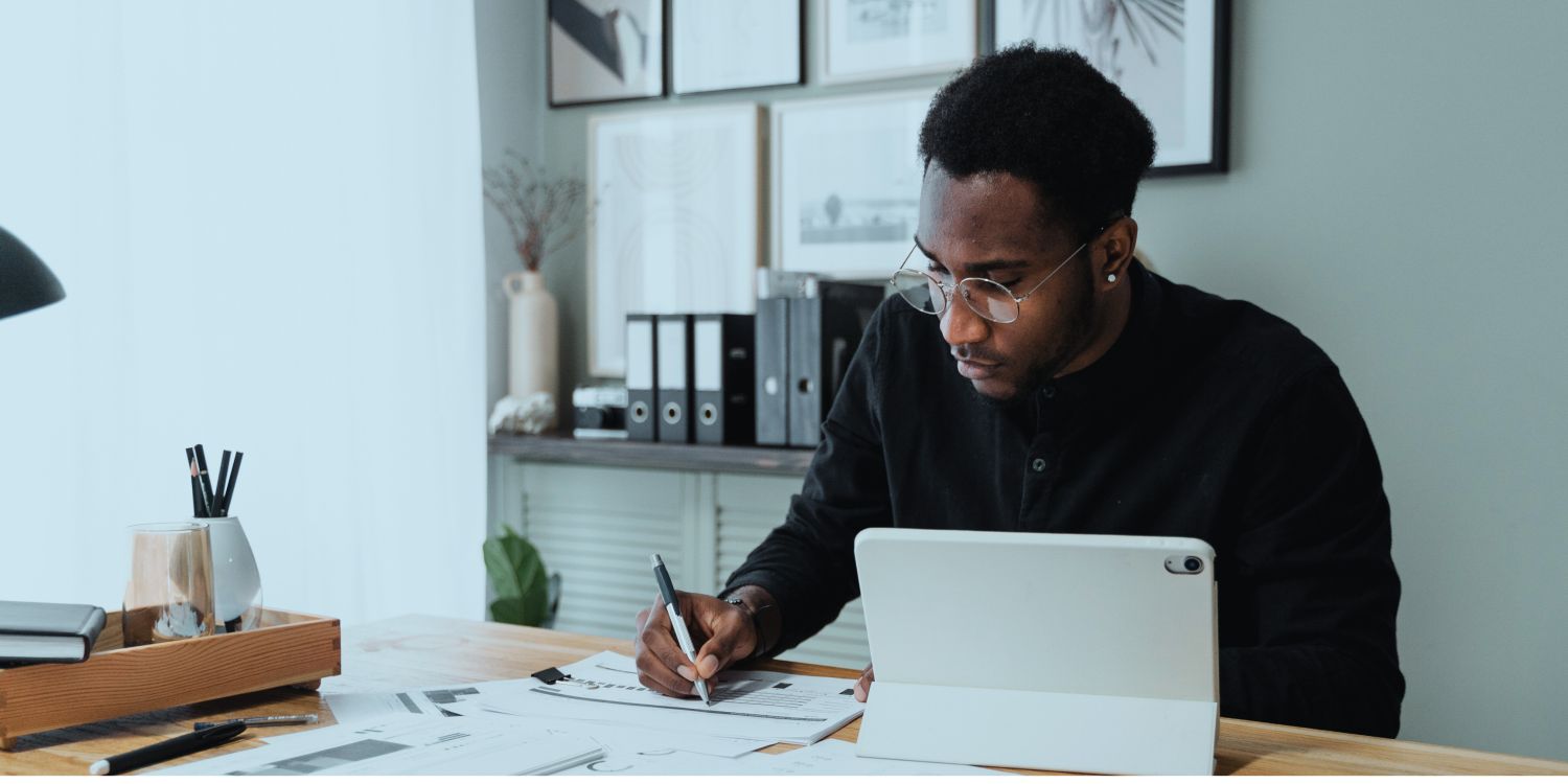 Male person signing a document
