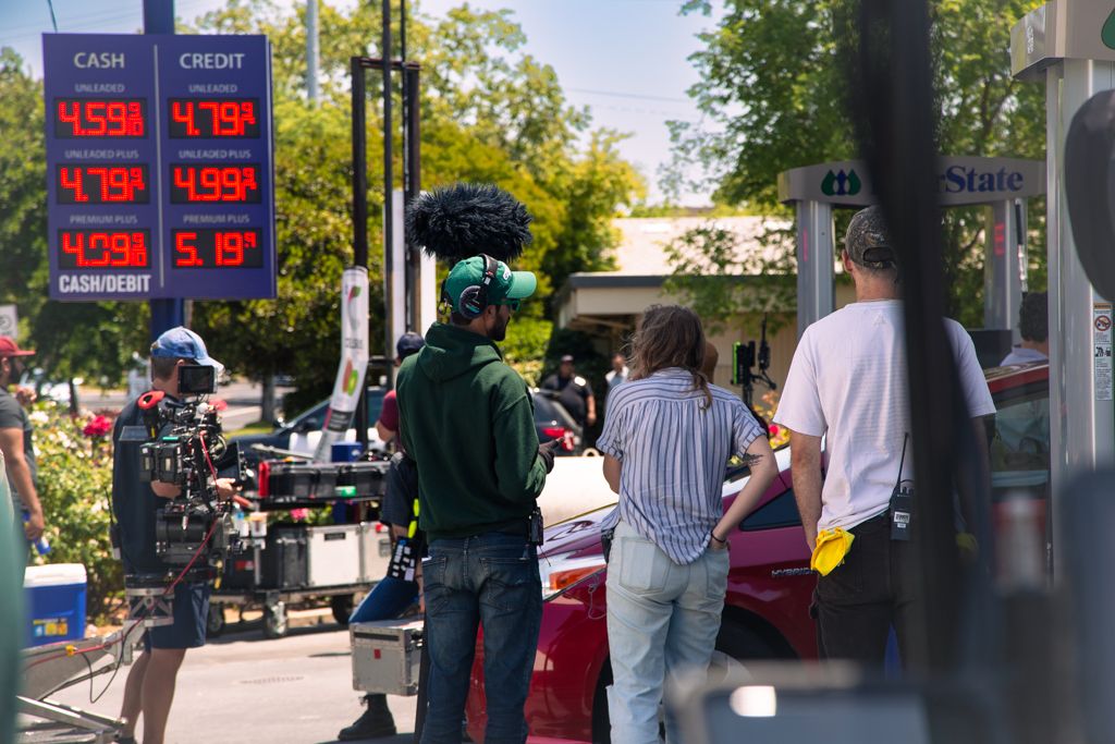 crew filming at gas station