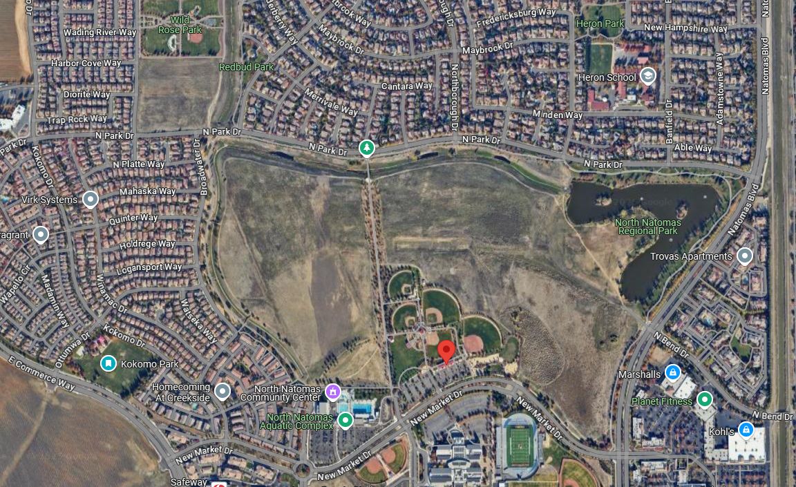 Satellite image of a large undeveloped area in the middle of suburban housing.