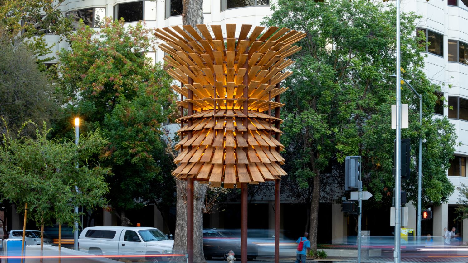 A 20' sculpture made from wooden slats radiating outward reminiscent of a tree trunk or barrel