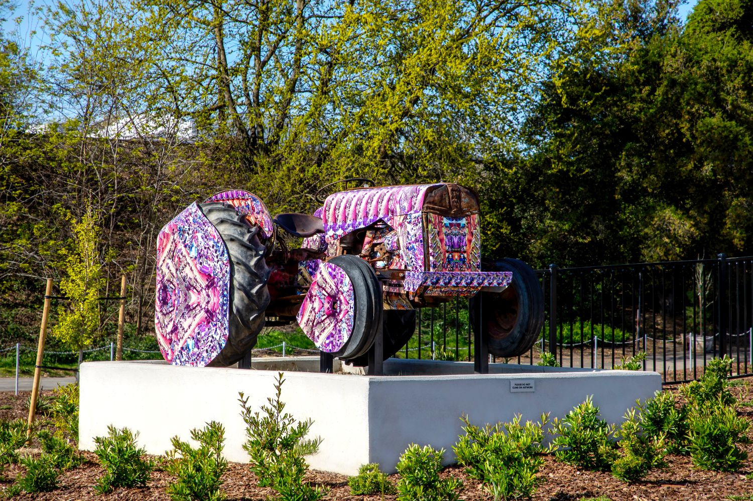 a pink, floral tractor sits atop a concrete slab