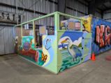 Ticket booth colorfully painted with birds, a turtle, beaver, and butterflies.