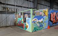 Ticket booth colorfully painted with birds, a turtle, beaver, and butterflies.