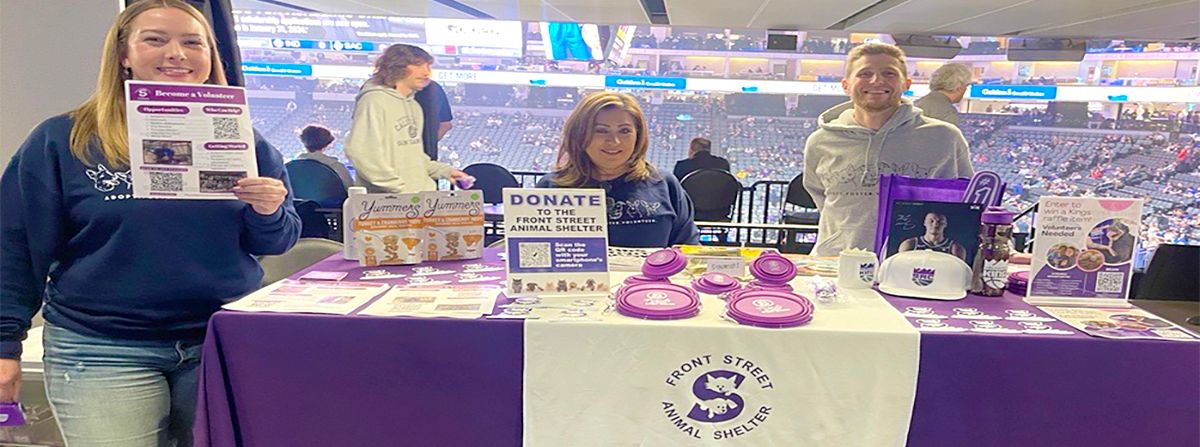 volunteers at a booth providing shelter information and asking for donations