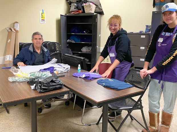 three volunteers working around a table