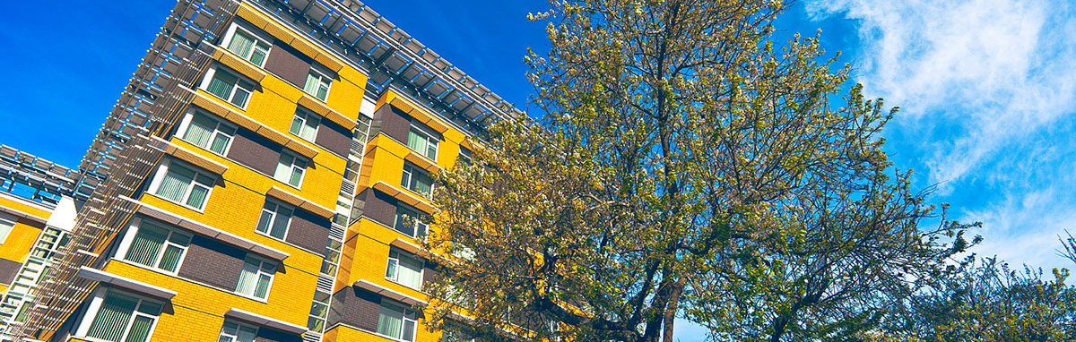 Image of a yellow housing building