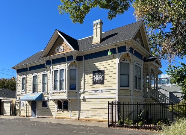 The Mercantile, a 2-story building with a black iron gate around the front and a sign on the side that says "The Merc"