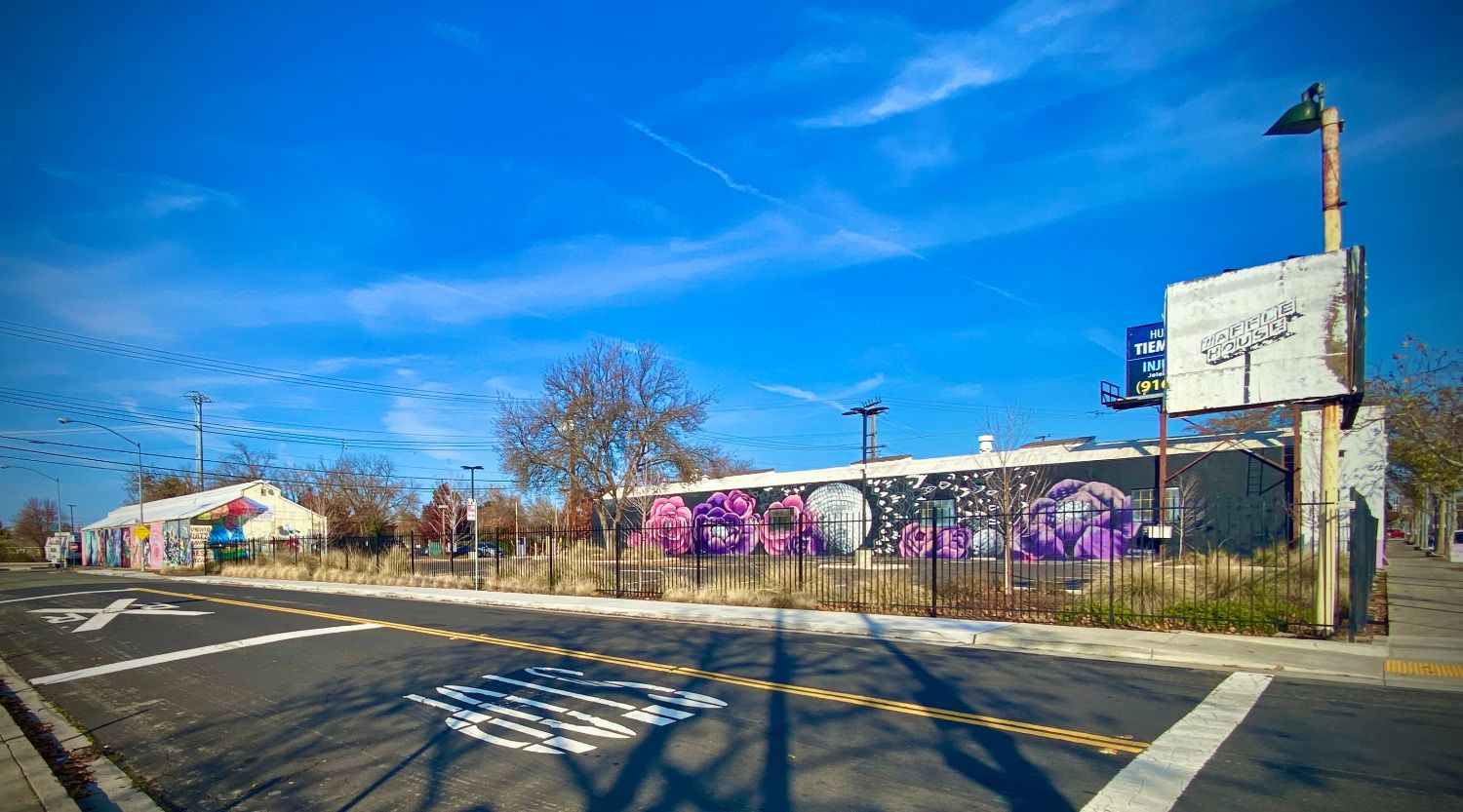 Stop at an intersection of Marysville and Del Paso Blvd. with a building with a mural on the side