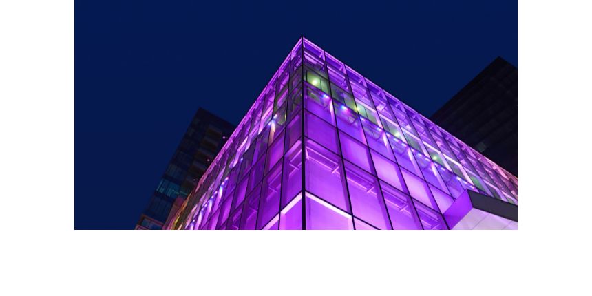 An abstract graphic showing a building lit with purple light.
