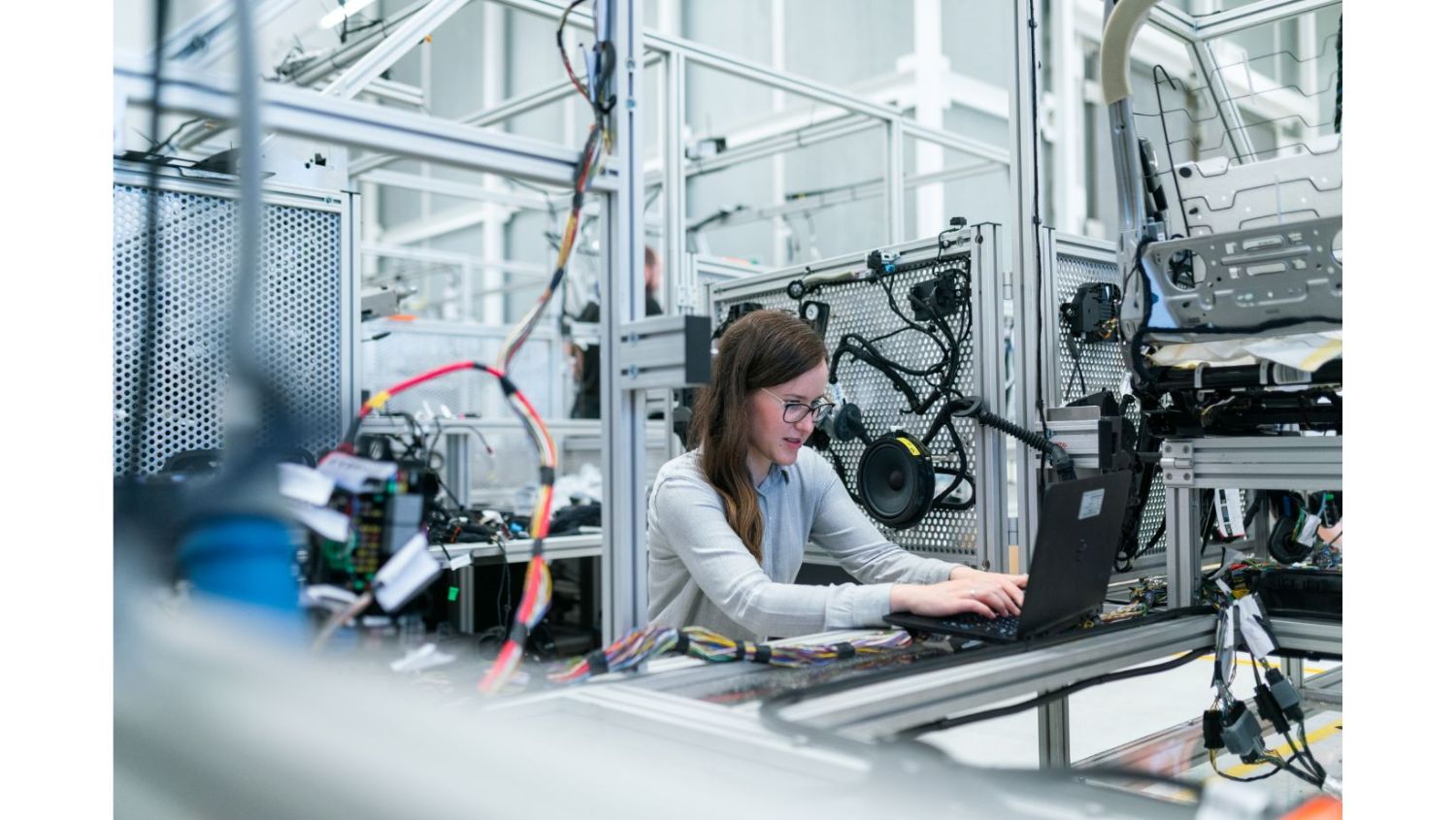 Photo of a female engineer in on a laptop in a high-tech workplace