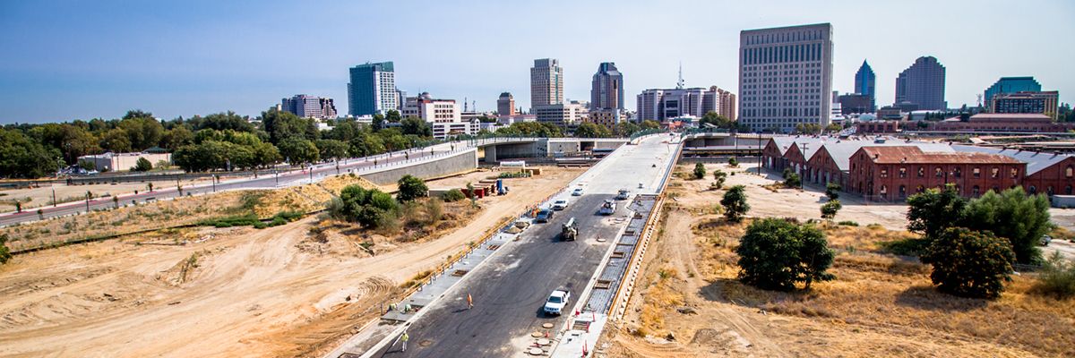 Image of road through undeveloped railyards section of Sacramento.