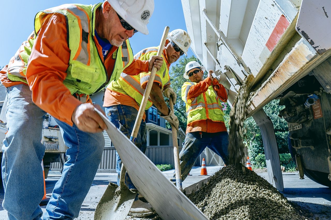 Utility workers filling a hole