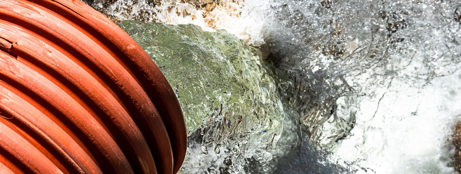 Image of water coming out of an orange pipe