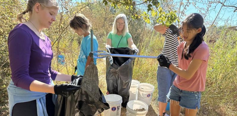 Image of a group of people picking up trash