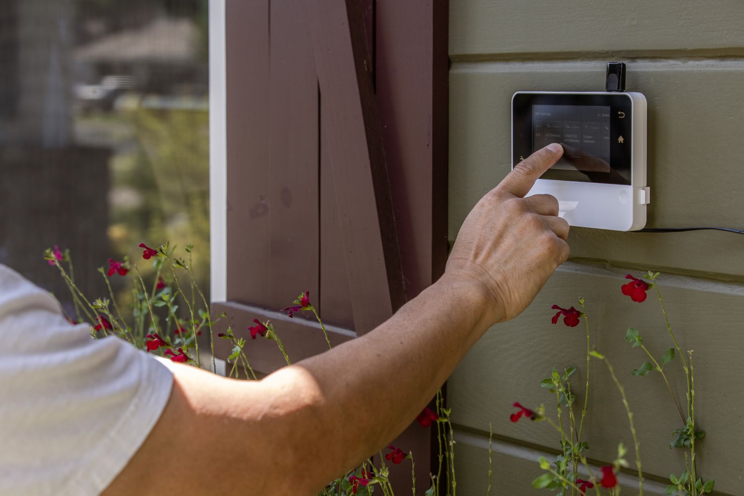 A man touching a smart landscape controller