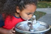 Girl drinking from water fountain