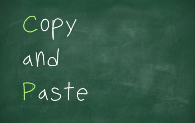 A green chalk board with the words Copy and Paste