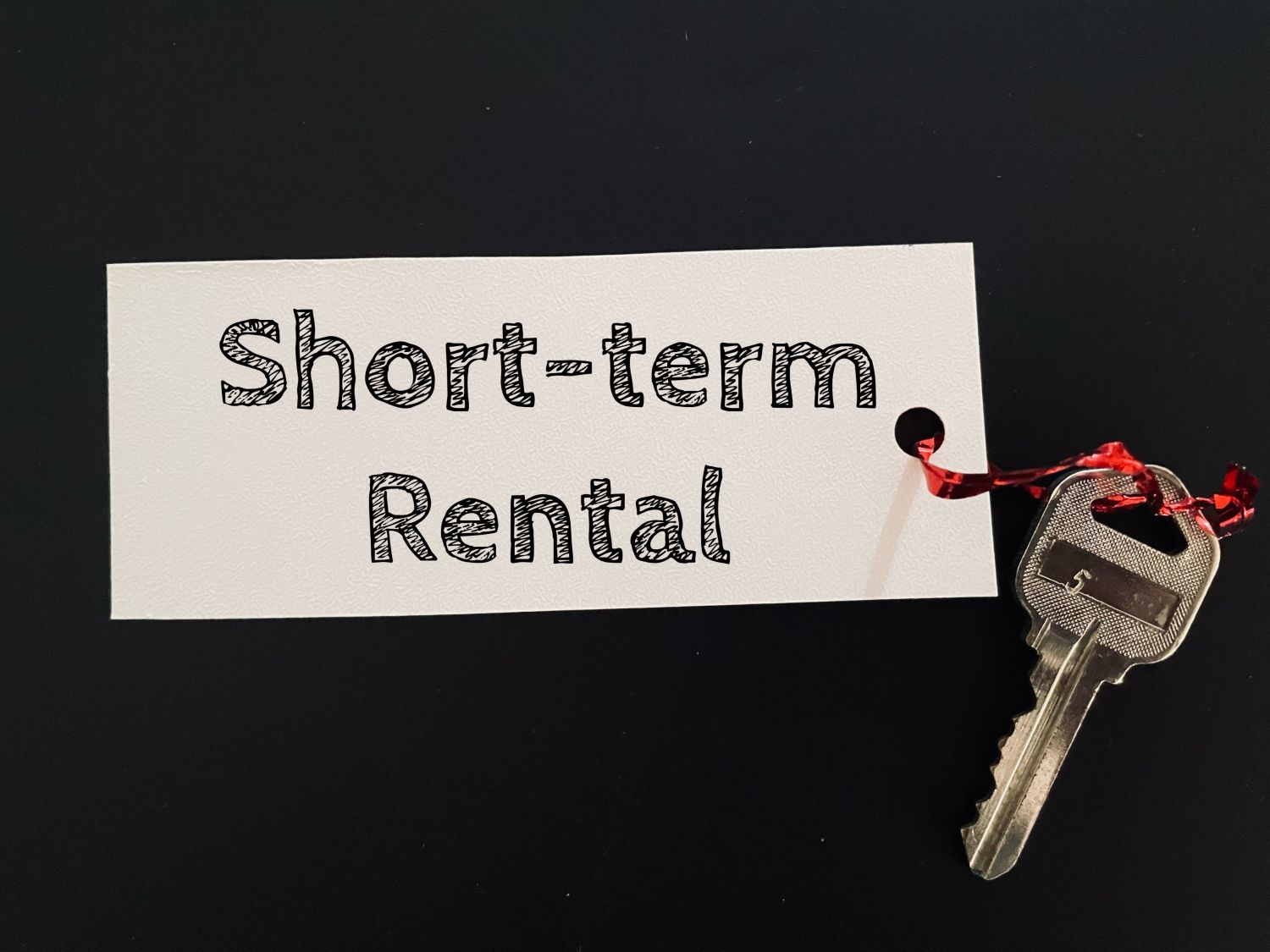 Short-Term Rental on tag with a key attached