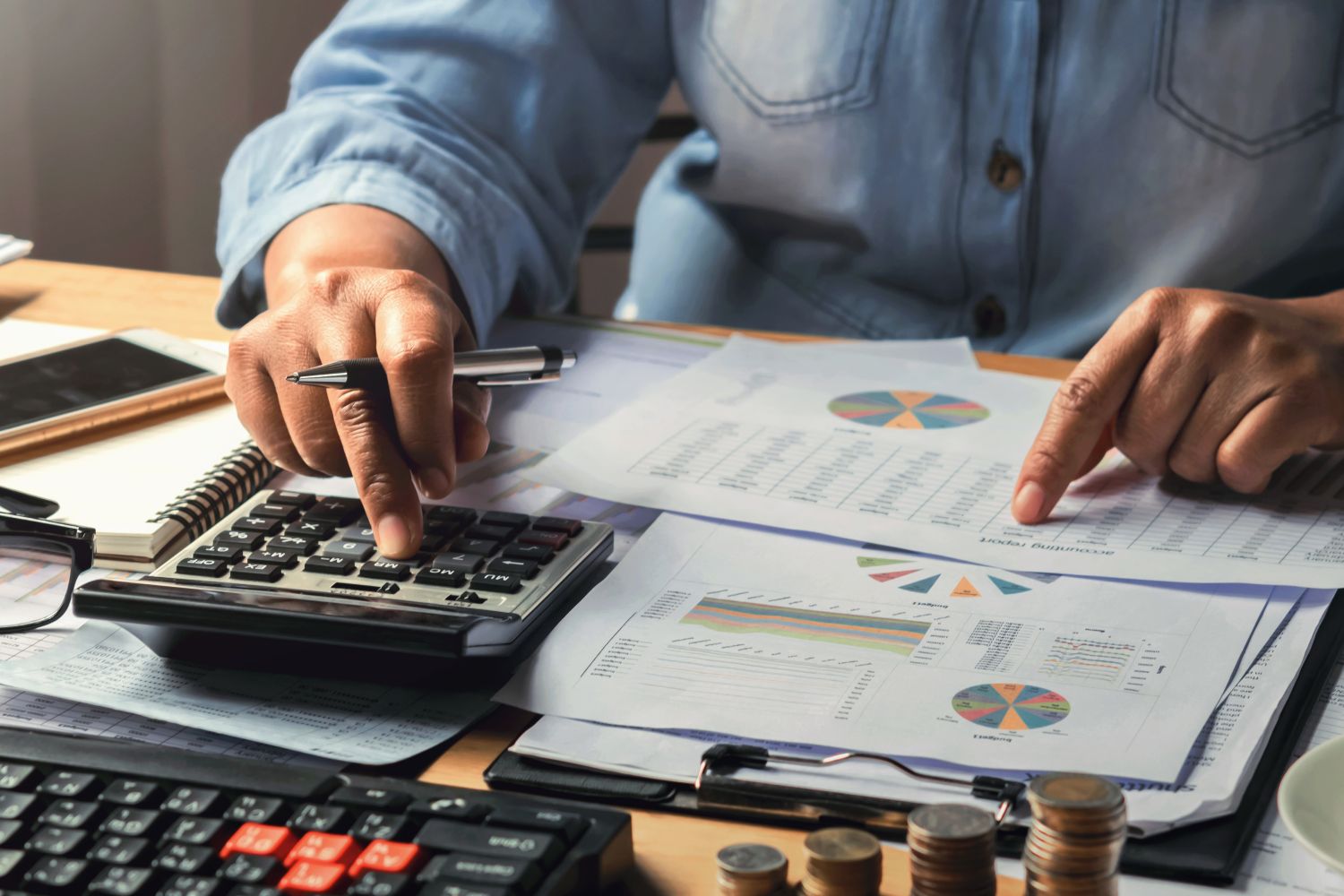 Man using calculator whil viewing graphs