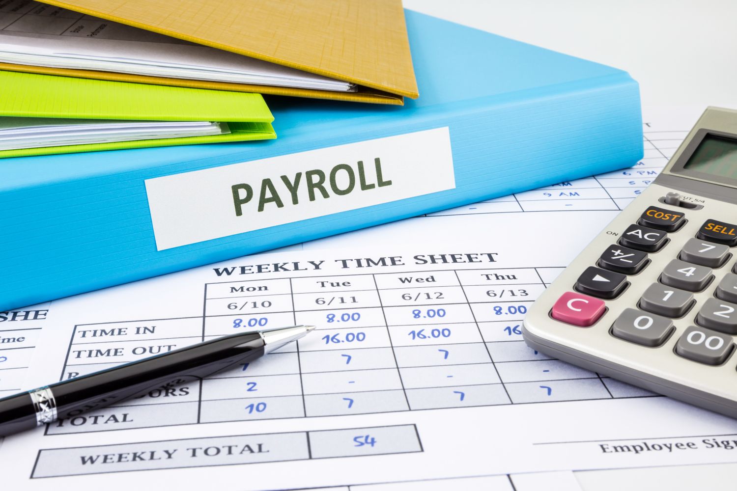 Time sheet and folder with the word Payroll on a sticker