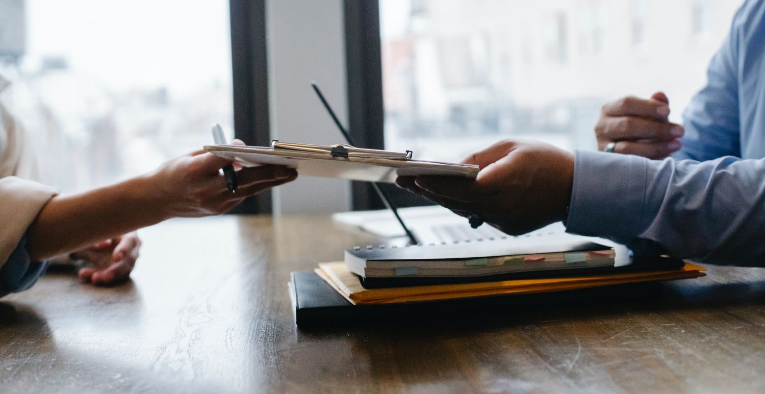 Handoff of paperwork from one person to the other