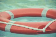 a red and white water floating device in the water