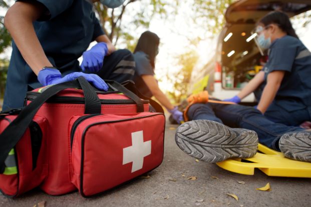 A medical bag and staff attending to a person