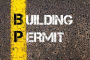 Asphalt road with a yellow stripe.  Overlaid by the words "Building Permit"
