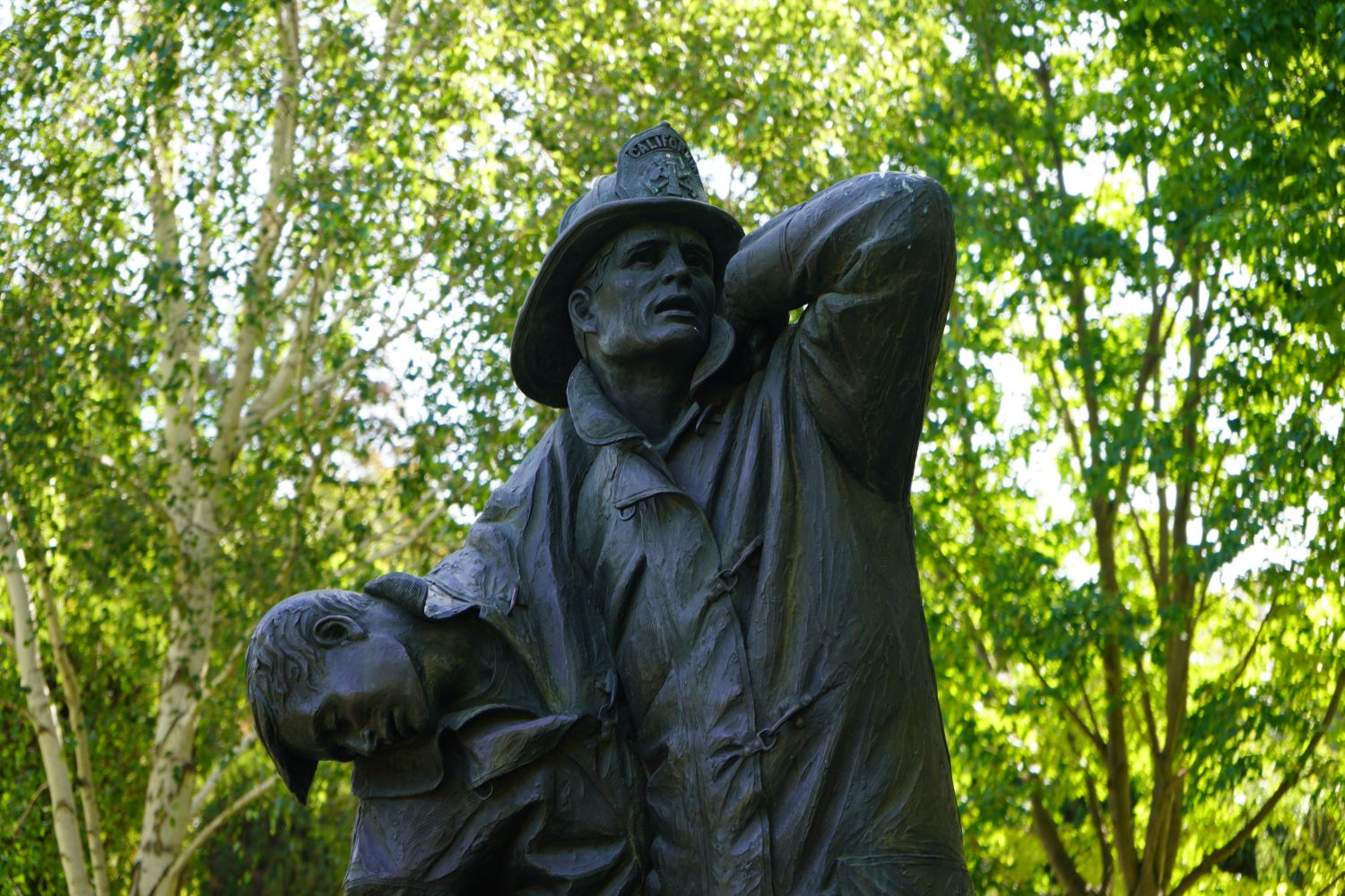 FRONT OF STATUE OF FIREFIGHTER HOLDING A FALLEN FIREFIGHTER