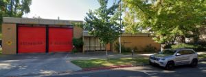 fire station made of brown brick with large red garage doors