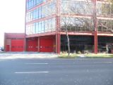 Fire station red building three red doors 