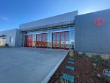 Fire station gray building with 3 glass doors 