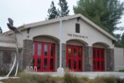 Fire Station brown building brick posts and 3 red glass doors 