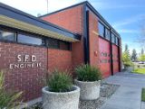 Fire Station 19 brick building with windows and red garage doors 