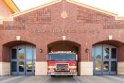 Fire Station 20 front of a brick building with windows and fire engine 