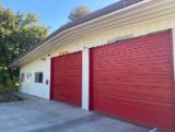 Station 3 White Building with two red garage doors 