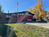 Fire Station 7 front of building with tree and flag pole 