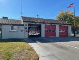 Station 57 front of building with two red garage door and fire truck inside building 